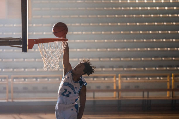 istock Basketball player dunking basketball 1498634475