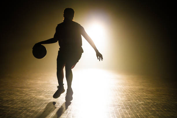 istock Basketball player dribbling ball 1498634481