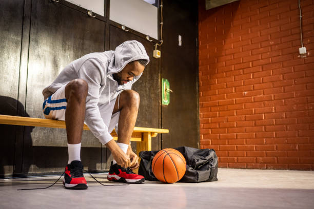 A high-top classic white leather basketball shoe sneaker isolated on black