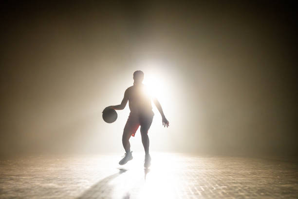 istock Basketball player dribbling ball 1498634498