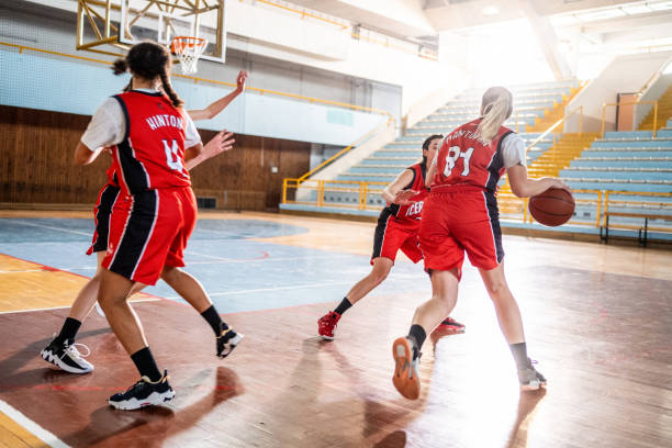 istock Basketball players playing on court 1498634511