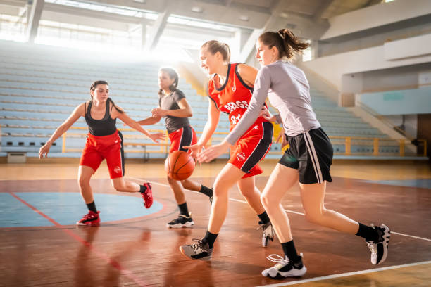 istock Basketball players playing on court 1498634514