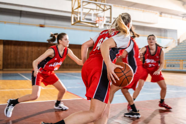 Basketball players playing on court Female basketball players playing basketball on court during practice. running to catch the train stock pictures, royalty-free photos & images
