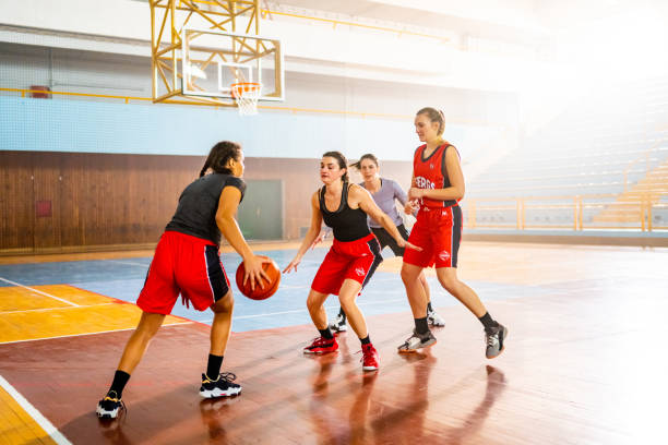 istock Basketball players playing on court 1498634549