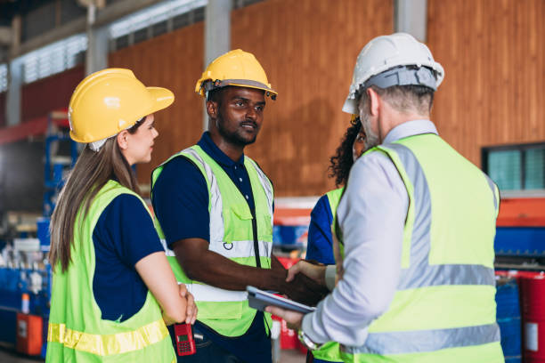 istock Team engineers and foreman stack hand and shake hands to show success at factory machines. Worker industry join hand for collaboration. 1498635849