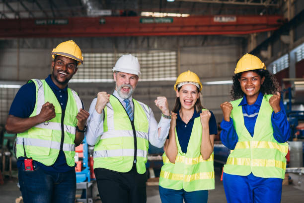 istock Team engineers and foreman stack hand and shake hands to show success at factory machines. Worker industry join hand for collaboration. 1498635884