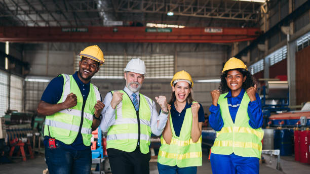 istock Team engineers and foreman stack hand and shake hands to show success at factory machines. Worker industry join hand for collaboration. 1498635913
