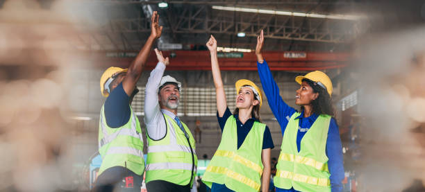 istock Team engineers and foreman stack hand and shake hands to show success at factory machines. Worker industry join hand for collaboration. 1498635981