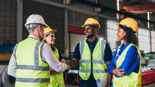 istock Team engineers and foreman stack hand and shake hands to show success at factory machines. Worker industry join hand for collaboration. 1498636016