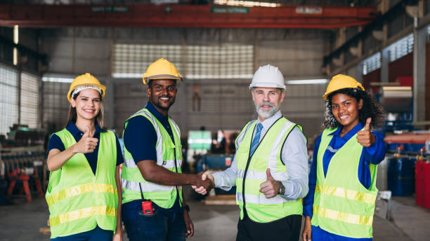 istock Team engineers and foreman stack hand and shake hands to show success at factory machines. Worker industry join hand for collaboration. 1498636036