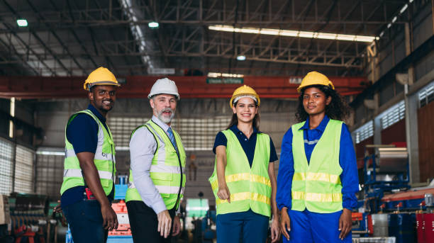 istock Team engineers and foreman stack hand and shake hands to show success at factory machines. Worker industry join hand for collaboration. 1498636607