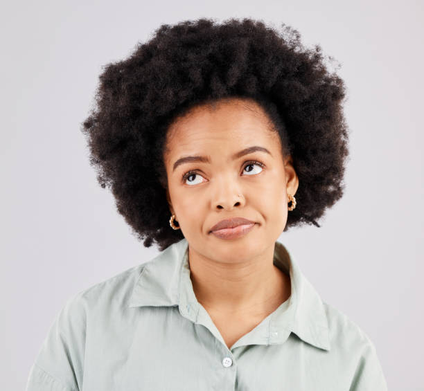 istock Thinking, doubt and face of black woman in studio for mockup, idea and promotion. Problem, information and confused with female isolated on white background for contemplating, sarcasm and tired 1498637179