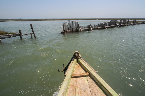 The front of a rowboat in the lagoon