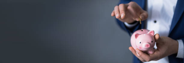 istock hand coin with piggy bank 1498638351