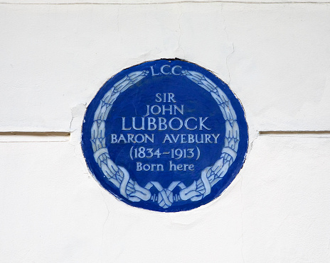 London, UK - March 14th 2023: Close-up of a blue plaque, located on Eaton Place in London, UK, marking the location where Sir John Lubbock - 1st Baron Avebury, was born in 1834.