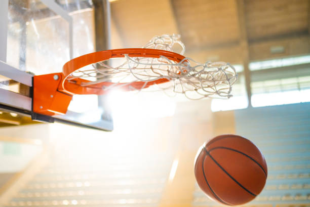 istock Basketball reaching in hoop 1498640342