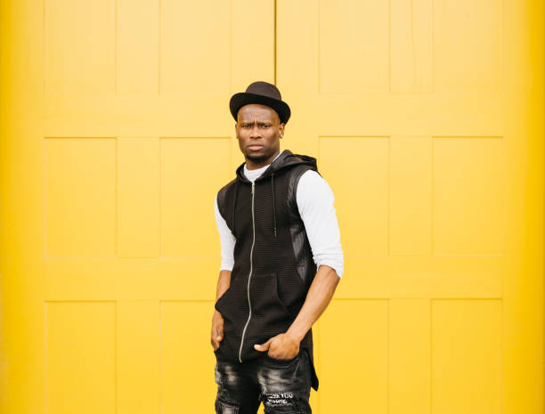 istock Young black male standing infront a yellow door 1498640707