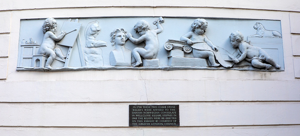 London, UK - March 14th 2023: A view of a beautiful Coade Stone relief sculpture on the exterior of the Norwegian Embassy building, located on Belgrave Square in London.