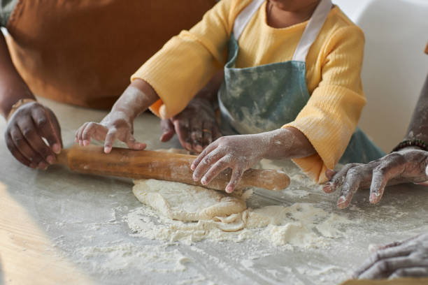 istock Little girl rolling the dough with rolling pin 1498642802