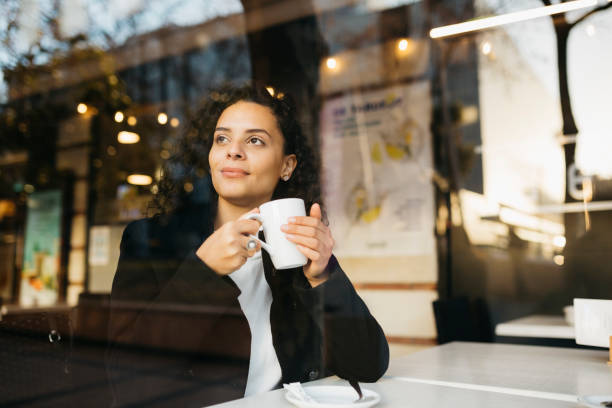 istock Woman drinking tea in a coffeeshop 1498644338