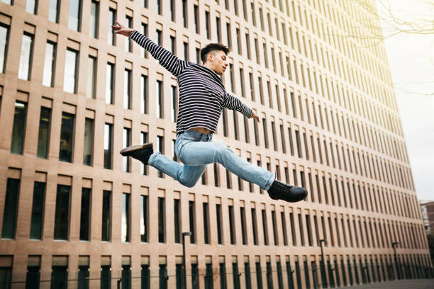 istock Active young man doing some dance moves on the street 1498644768