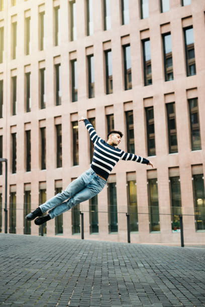 istock Active young man doing some dance moves on the street 1498644822