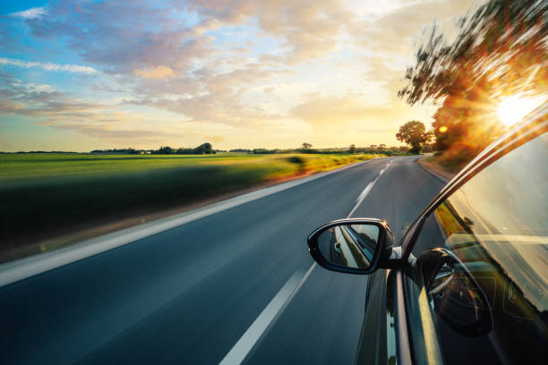 A car is driving on the highway, the environment is blurred