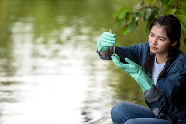 istock Asian student biology taking and testing sample of natural river water. Experts science women keep water for research analysis in the laboratory. Environmental pollution Concept 1498647731