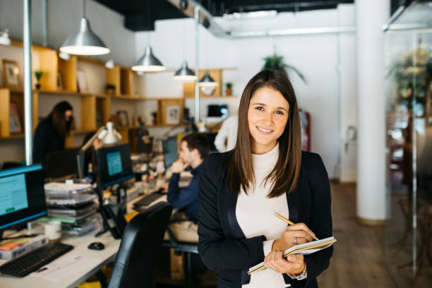 istock Business woman taking notes on a notebook as she works in an office 1498648134