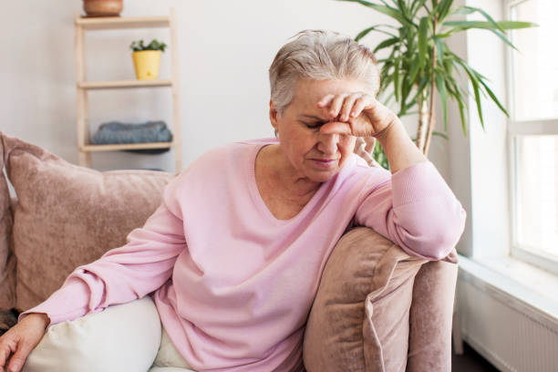 istock middle aged lady looking away sit alone at home feel anxious lonely, sad 1498649369