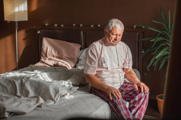 istock Seated in bed in the morning senior man 1498649810