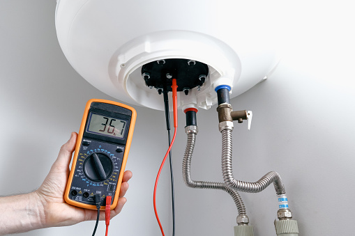 Heating Element Continuity Test Men Using Multimeter To Test Heating Element Appliance Engineer Using A ...
