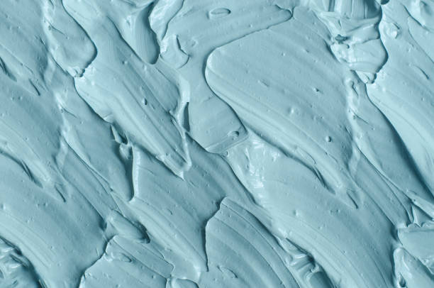 istock Light blue bentonite facial clay (alginate modeling mask, face cream, body wrap) texture close-up, selective focus. Abstract background with brush strokes. 1498653676