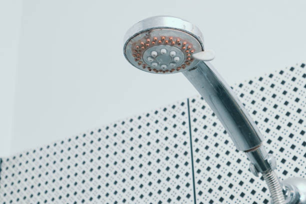 istock Silver shower head with limescales. Shower damaged from water scale. 1498654070