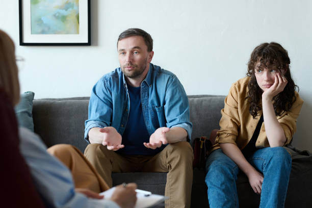istock Man talking to psychologist about problems with wife 1498654140