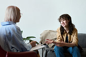 Young woman talking to therapist at session