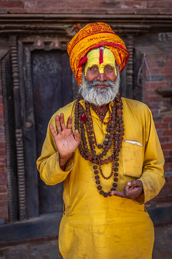 Kathmandu, Nepal - November 4 2018: Old Hindu saint happily posing for a photo.