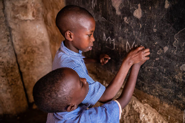 istock African little boys are learning English language, orphanage in Kenya 1498654903