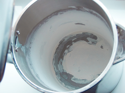Kettle with white limescale surface - hard water concept. A white, chalky residue from deposit of calcium carbonate.