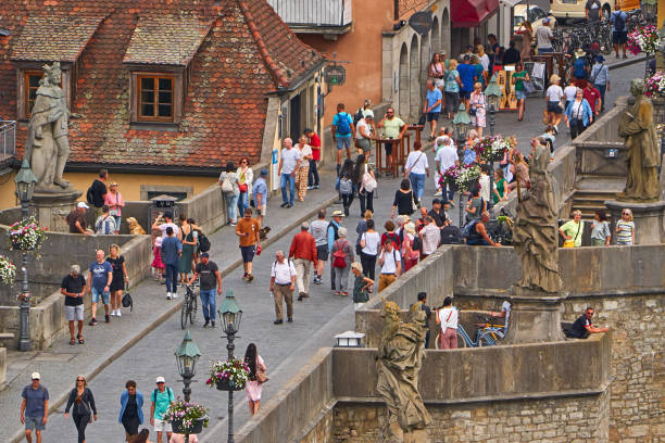 Wuerzburg, Germany - June 16, 2023: Crowd on the old Main Bridge in summer