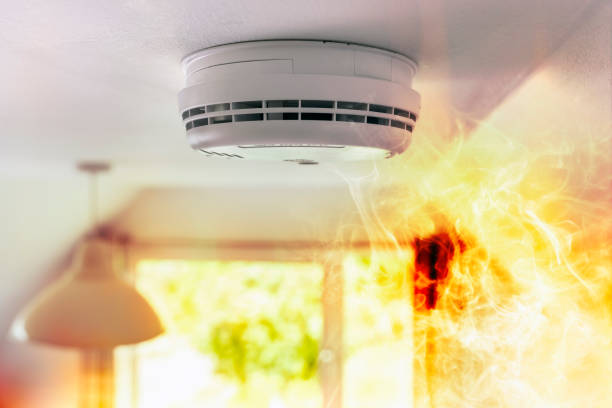 istock Smoke detector and interlinked fire alarm on ceiling in action background 1498656534