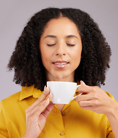 Relax, enjoying aroma and a woman drinking coffee isolated on a white background in studio. Calm, content and a girl with a warm beverage or cup of tea for relaxation, peace or a break on a backdrop