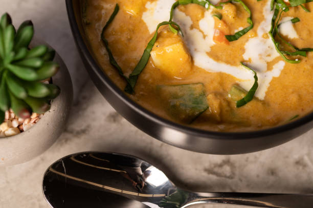 istock Coconut Curry Dish in a Black Bowl on a Marble Counter 1498659159