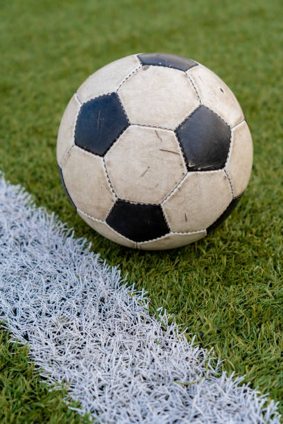 un vecchio pallone da calcio giace sul prato dello stadio - lawn ball circle green foto e immagini stock
