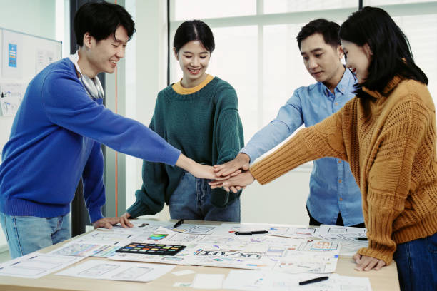 istock ux developers and ui designers use augmented reality to brainstorm on mobile app and web site page interface wireframe designs on modern office desks. successful, deal, success, together concepts. 1498664551