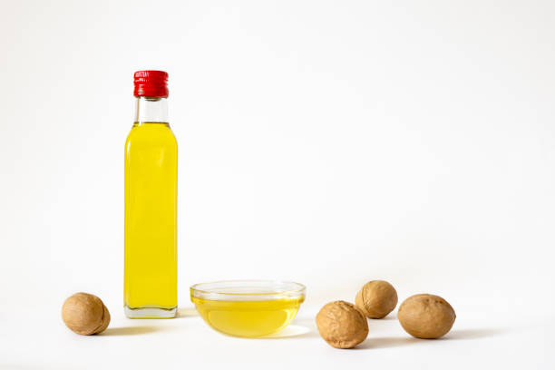 Walnut oil in bottle on white background with copy space.