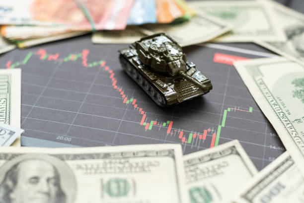 istock a toy tank, dollars and a tablet 1498669598