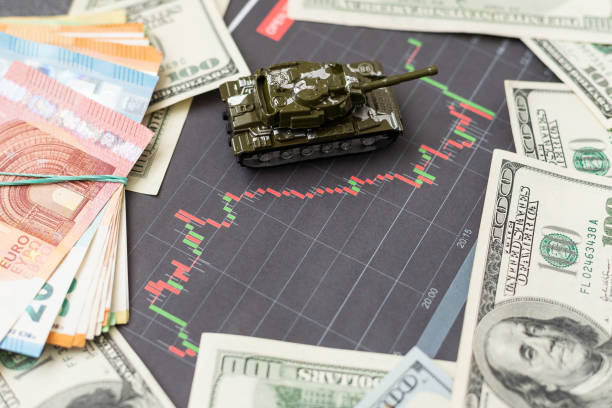 istock a toy tank, dollars and a tablet 1498669652