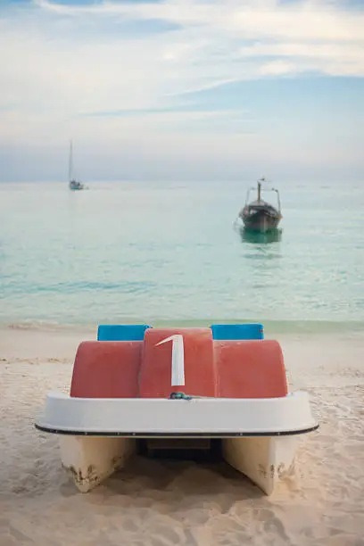 A dreamy scene of a rental paddleboat on the fine white sand beach in Koh Lipe (Ko Lipeh), Thailand