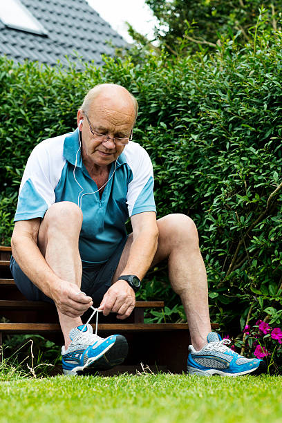 istock Senior man is tying a sports shoe before running 149867093